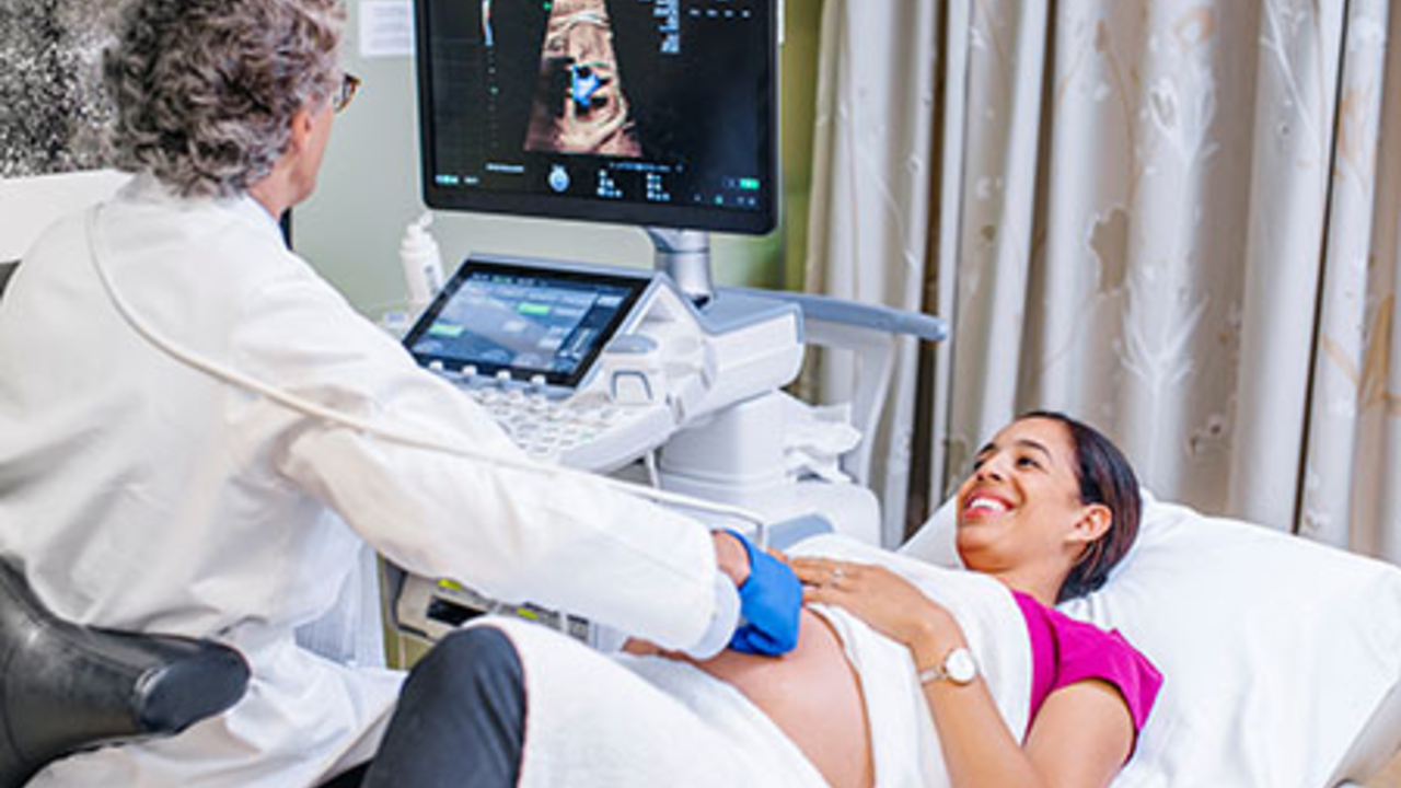 Doctor taking ultrasound of pregnant woman