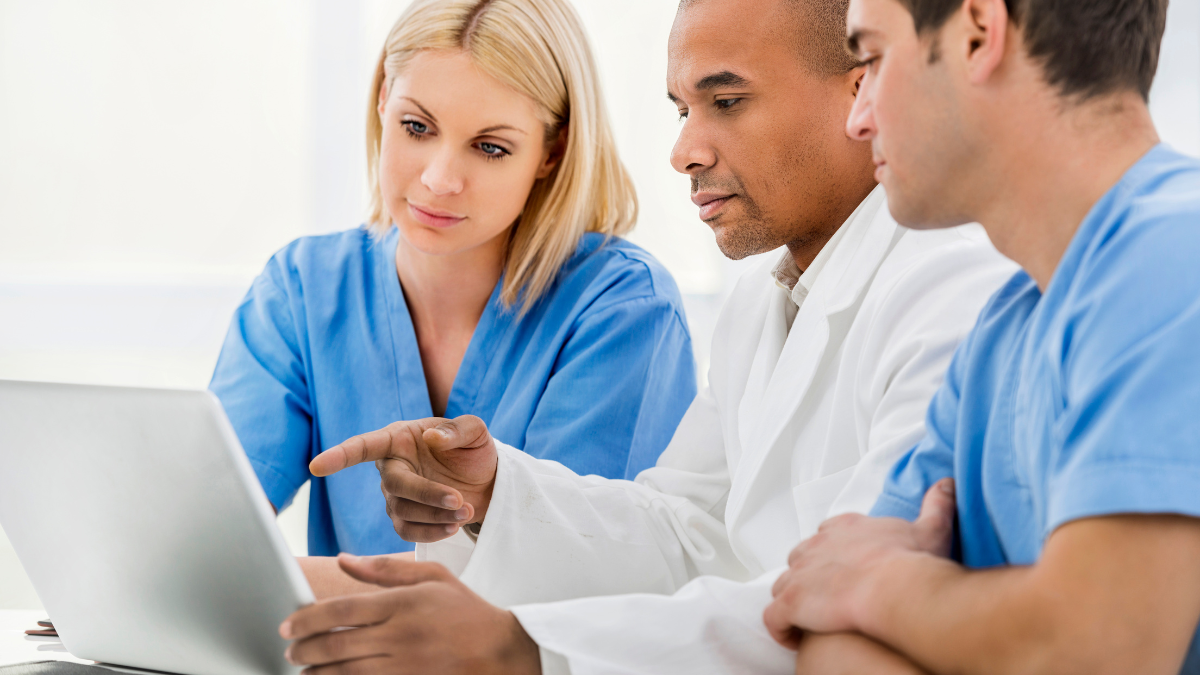 Medical team reviewing a tablet