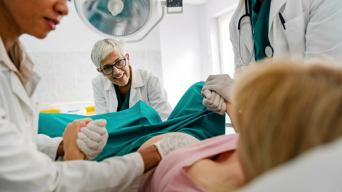 Female clinician delivering baby